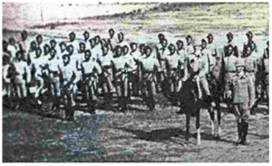 The Gurkha Rifles, with British Officers, on parade in service dress carry their Pipes under their arm